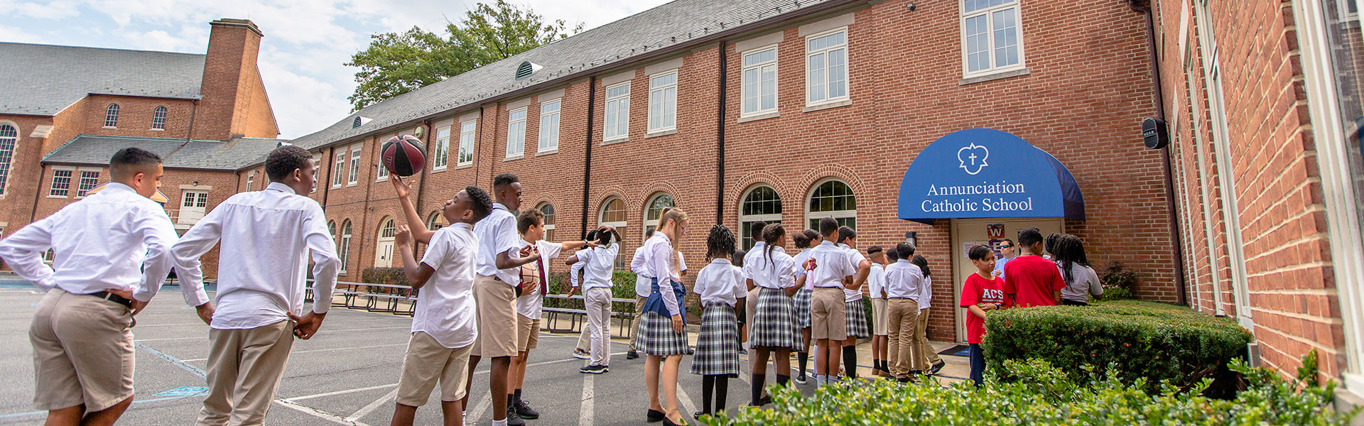 annunciation-history kids playing outside of annunciation catholic school